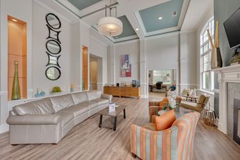 Clubhouse rest area with a white couch and a fireplace.